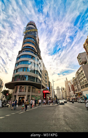 Madrid, Spain - June 20, 2019: Sunset on Gran Via, with the emblematic Capitol building in the background, in the center of the city of Madrid Stock Photo