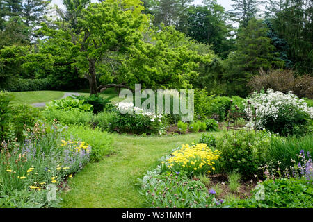 A path through the perennial garden at Berkshire Botanical Garden in Stockbridge, Massachusetts in early summer. Stock Photo