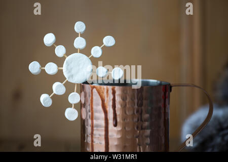 Hot chocolate decorated with a marshmallow snowflake Stock Photo