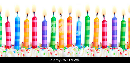 Brightly colored birthday cake candles against a white background Stock Photo