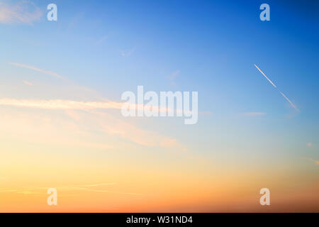 Blue and orange colored sky just before summer sunrise. Beautiful dawn skyscape. Clear paradise sky. Calm heaven background. Stock Photo
