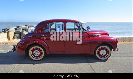Classic Red 1953 Morris Oxford Motor Car Parked on Seafront Promenade. Stock Photo