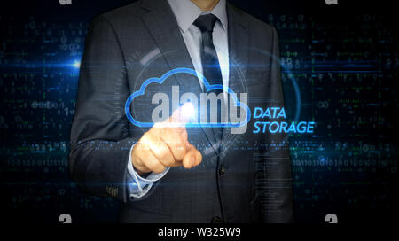 A businessman in a suit touch the screen with cloud symbol hologram. Man using virtual display interface. Data computing, online storage and digital d Stock Photo