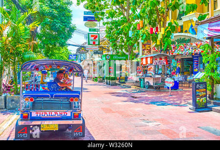 BANGKOK, THAILAND - APRIL 22, 2019: The tuk-tuk driver waits for clients on empty Ram Buttri road, on April 22 in Bangkok Stock Photo