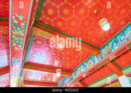 BANGKOK, THAILAND - APRIL 22, 2019: The beautiful wooden ceiling with colorful decorationsin Sala Rai shrine of Wat Pho complex, on April 22 in Bangko Stock Photo