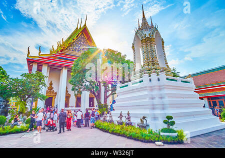 BANGKOK, THAILAND - APRIL 22, 2019: Splendid architecture of Wat Pho religion complex with its unique tiled decorations attracts tourists, on April 22