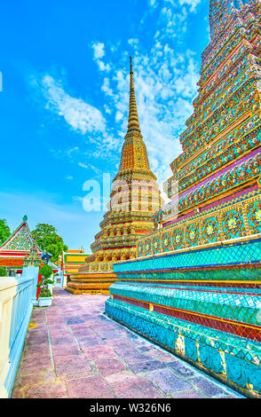 The large stupas of Phra Maha Chedi decorated with colorful floral tiled patterns, Wat Pho shrine, Bangkok, Thailand Stock Photo