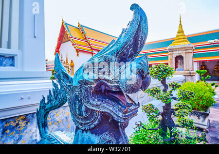 The muzzle of the bronze Singha with open mouth, the mythological lion, guards the entrance to Phra Ubosot temple in Wat Pho complex in Bangkok, Thail Stock Photo