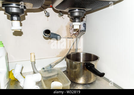 Drain of a sink pipe clogged with dirt, disassembled by a plumber to unclog it. Stock Photo