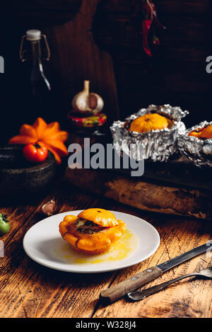Yellow pattypan squash stuffed with minced meat, leek, carrot, garlic and spices Stock Photo