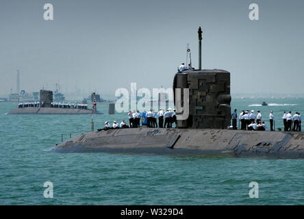 AJAXNETPHOTO. 27TH JUNE, 2005. PORTSMOUTH, ENGLAND - T200 INTERNATIONAL FLEET REVIEW - THE CREW OF HMS TRAFALGAR RELAX ON DECK WHILE WAITING FOR REHEARSALS TO BEGIN. PHOTO:JONATHAN EASTLAND/AJAX REF:D1 52706 192 Stock Photo