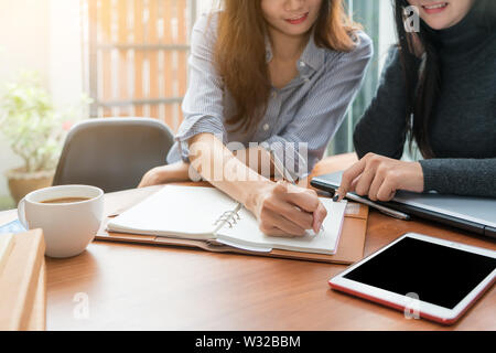 Two Asian business woman working together with in office. Business team concept Stock Photo