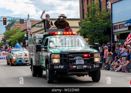 Smokey the Bear rideing in US Forest Service truck; annual Fourth of July Parade in the small mountain town of Salida.; Colorado; USA Stock Photo