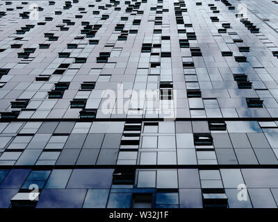 Abstract metallic background. Diminishing perspective of modern building wall and windows. Stock Photo