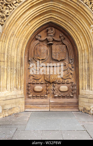 Wooden West doors dating from 1611 with inscription and crests, Bath Abbey in the centre of Bath, the largest city in Somerset, south-west England, UK Stock Photo