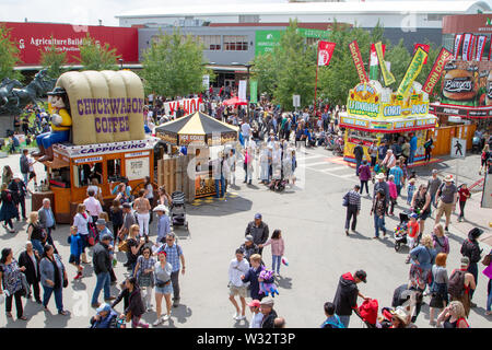 CALGARY, CANADA - JULY 9, 2019: A crowd filled the street on Olympic Way SE at the annual Calgary Stampede event. The Calgary Stampede is often called Stock Photo