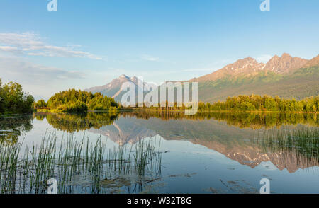 Reflection of Pioneer Peak and Twin Peaks on Reflections Lake in Palmer Hay Flats State Game Refuge in Southcentral Alaska. Stock Photo