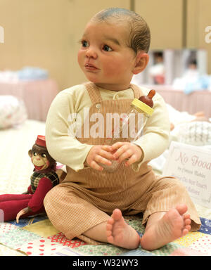 Layton, Utah, USA. 11th July, 2019. A reborn baby doll is displayed in the contest hall at the 6th Annual R.O.S.E International Doll Expo, a showcase for ultra realistic ''reborn'' baby dolls. Fashioned meticulously from viny and silcone, and weighted with glass beads and other materials for maximum realism, these collectible dolls have also been employed as emotional, cuddle therapy for dementia patients. Credit: Brian Cahn/ZUMA Wire/Alamy Live News Stock Photo