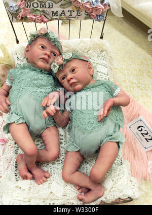 Layton, Utah, USA. 11th July, 2019. Reborn baby dolls are displayed in the contest hall at the 6th Annual R.O.S.E International Doll Expo, a showcase for ultra realistic ''reborn'' baby dolls. Fashioned meticulously from viny and silcone, and weighted with glass beads and other materials for maximum realism, these collectible dolls have also been employed as emotional, cuddle therapy for dementia patients. Credit: Brian Cahn/ZUMA Wire/Alamy Live News Stock Photo