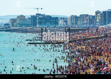 UK June 29th, 2019 Brighton beach, Brighton and Hove, East Sussex, England. Thousands of people relax on the sun. Stock Photo