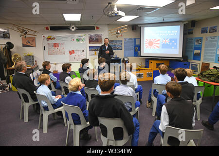 CHRISTCURCH, NEW ZEALAND, DECEMBER 12, 2018: School boys take in a lesson on New Zealand history at the Air Force Museum. Stock Photo