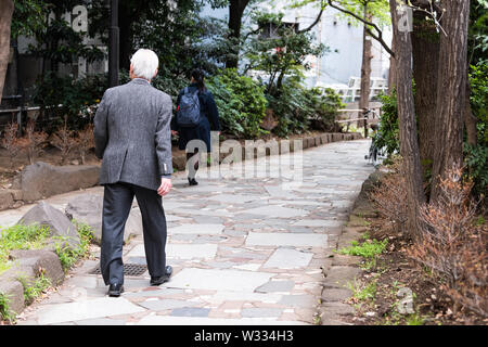 Tokyo, Japan - April 1, 2019: Shinjuku boardwalk Park called four seasons road or lane with people walking on pathway by Golden gai alley Stock Photo