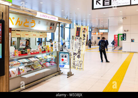 Utsunomiya, Japan - April 4, 2019: Retail food store shop selling ekiben bento boxes in JR train rail station with people walking inside Stock Photo