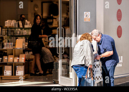 London, UK - September 13, 2018: Chelsea shopping street with people walking, senior old couple standing with bags looking at receipt by M&S or Marks Stock Photo