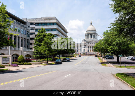 Little Rock, USA - June 4, 2019: State Capitol of Arkansas on sunny day with street road and cars parked in summer Stock Photo