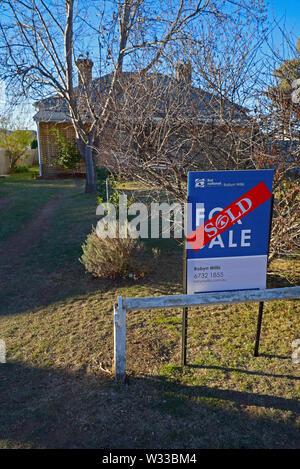 sold sticker across a sold sign outside a house in the northern new south wales town of Glen Innes, australia Stock Photo