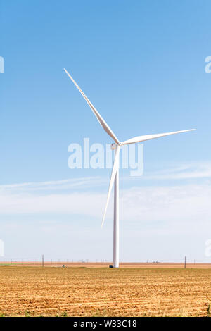 Wind turbine closeup with farm rual field near Snyder Texas in USA isolated and sky Stock Photo