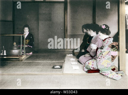 [ 1900s Japan - Japanese Tea Ceremony ] —   Tea Ceremony: Receiving the tea. This image comes from “The Ceremonial Tea Observance in Japan,” published in 1907 (Meiji 40) by photographer Kozaburo Tamamura, and later by Teijiro Takagi.  10 of 14  20th century vintage collotype print. Stock Photo