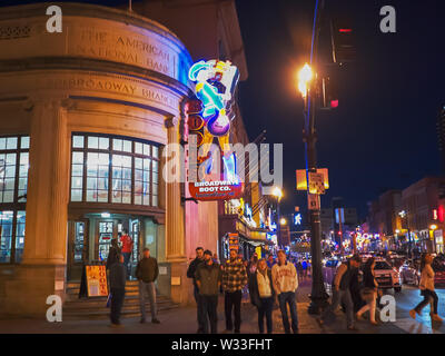 NASHVILLE, USA -April, 6, 2017: walking across street towards a neon sign in nashville, tn Stock Photo