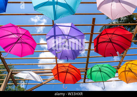 Street decorated with colored umbrellas, island Koh Phangan, Thailand. Hanging colorful umbrellas, on the outdoors Stock Photo