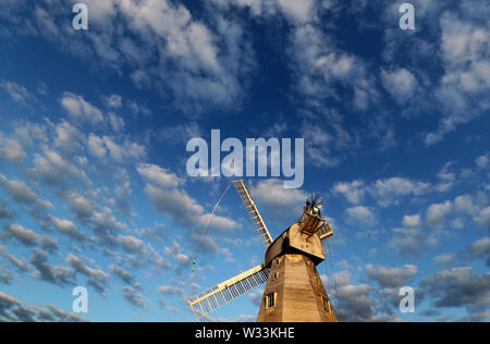 A view of Willesborough Windmill, a restored and working white smock mill built in 1869 in Ashford, Kent, during the morning sunlight. Stock Photo