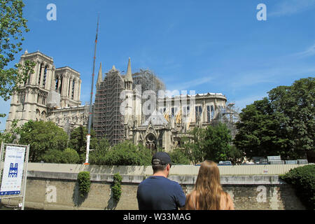 10 July 2019, France, Paris: The partially scaffolded cathedral of Notre-Dame. Three months ago a devastating fire had partially destroyed the cathedral on 15.04.2019. Photo: Julia Naue/dpa Stock Photo