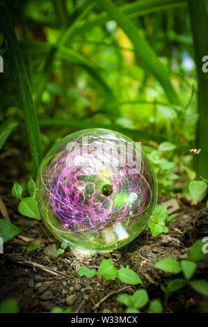 Magic crystal ball atom in nature for summer fantasy imagery Stock Photo