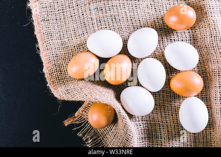 Eggs on tablecloth over black background Stock Photo