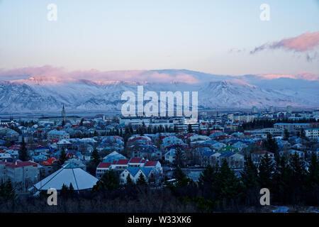 Wide angle 120° sunset panorama of East Reykjavik city in winter with snowcapped mountain view in the background from top of perlan tower (Pic 5/7)