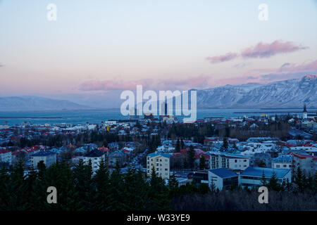 Wide angle 120° sunset panorama of East Reykjavik city in winter with snowcapped mountain view in the background from top of perlan tower (Pic 3/7)