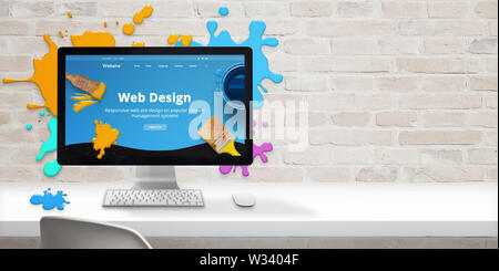 Web design studio concept with modern web site teme and web design text on computer display surrounded by color drops. Free space beside on brick wall Stock Photo