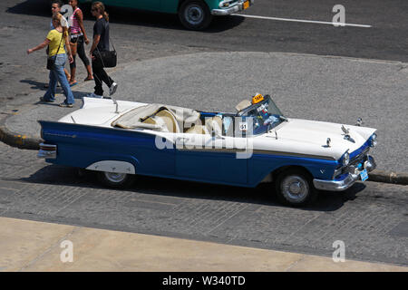 Havana, Cuba - July 2, 2019: A classic car turned into a taxi pulls up in the center of Havana, Cuba. Stock Photo
