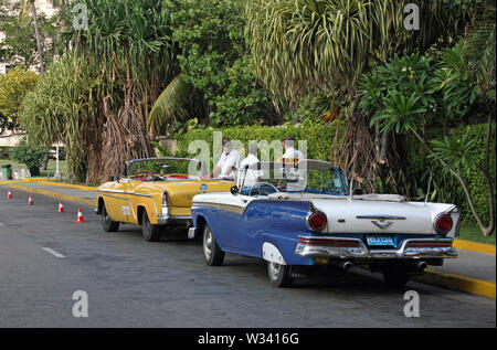 Havana, Cuba - July 2, 2019: Taxi driver standing next to their classic cars in Havana, Cuba. Stock Photo