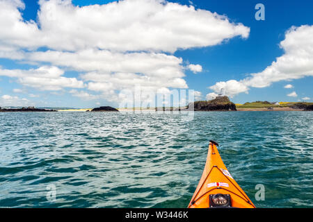 Approaching Ynys Llanddwyn or Llanddwyn Island by sea kayak. West coast of Anglesey, North Wales,UK Stock Photo