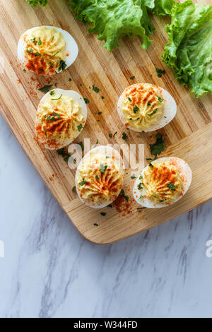 Stuffed Russian deviled eggs topped with parsley and paprika Stock Photo