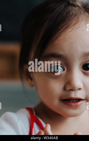Portrait of a happy Asian little toddler girl. Stock Photo