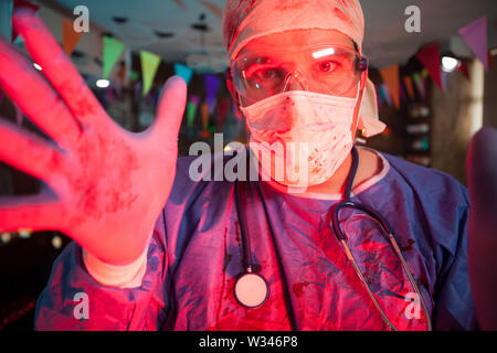 Close up of doctor with blood on his costume at halloween party. Celebrating halloween. Stock Photo