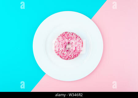 Donut covered with icing in plate, top view Stock Photo