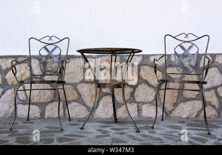 Table and chair in garden Stock Photo