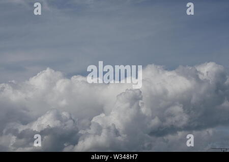 White cummulus  clouds on a bright blue sky  summers day Stock Photo